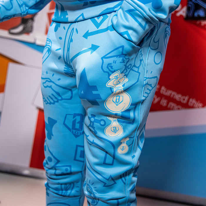 Youth model wearing blue youth joggers with “Grand Slam Collector Relaxed Fit” design