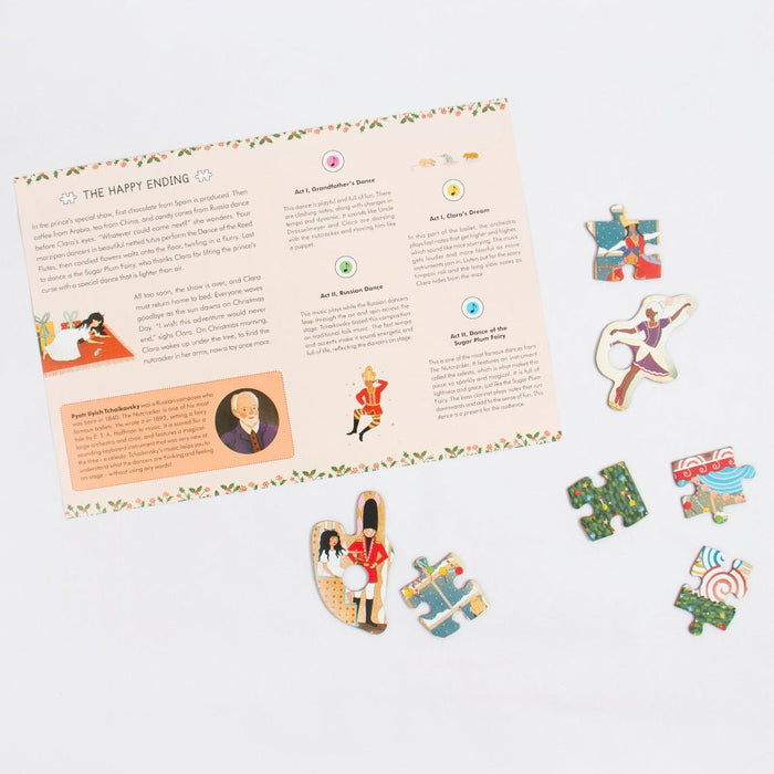 A printed story board or instruction sheet titled 'THE HAPPY ENDING' with colorful illustrations and several small illustrated puzzle-piece pieces arranged around it on a clean white background.