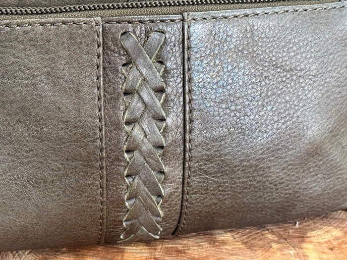 Braided leather panel detail on dark olive zippered crossbody purse