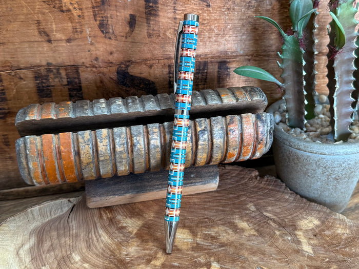 Turquoise Aztec-style ballpoint pen with silver cap and pointed tip