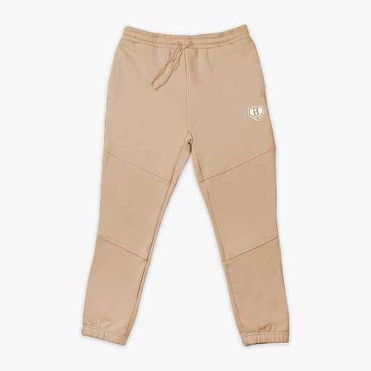 Beige sweatpants with a white BL101 logo on a white background