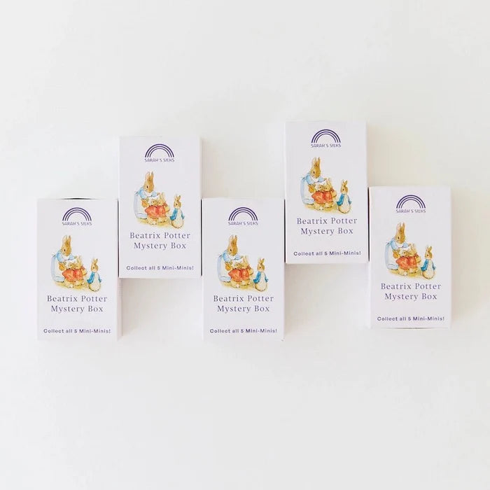 Five white boxes of Beatrix Potter Mystery Box collectible mini-minds arranged on a plain white background.