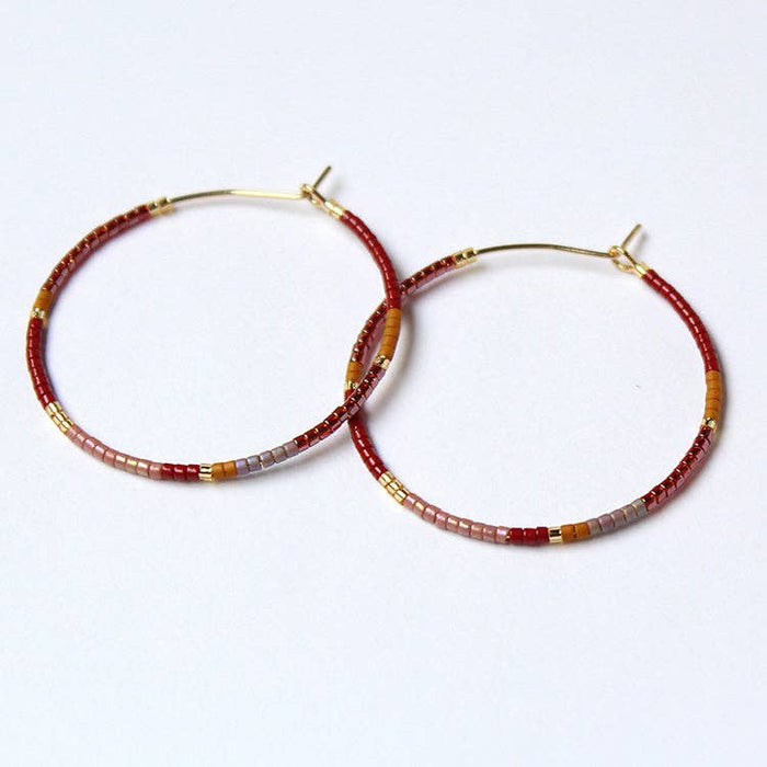 Beaded hoop earrings, gold-tone hoops with red, brown, gray and gold bead accents.