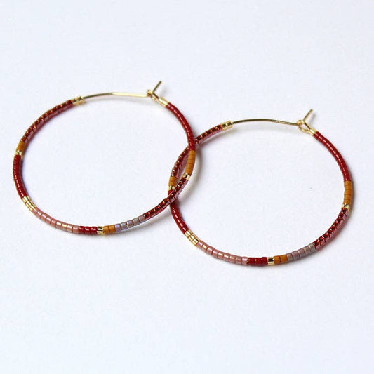 Beaded hoop earrings, gold-tone hoops with red, brown, gray and gold bead accents.