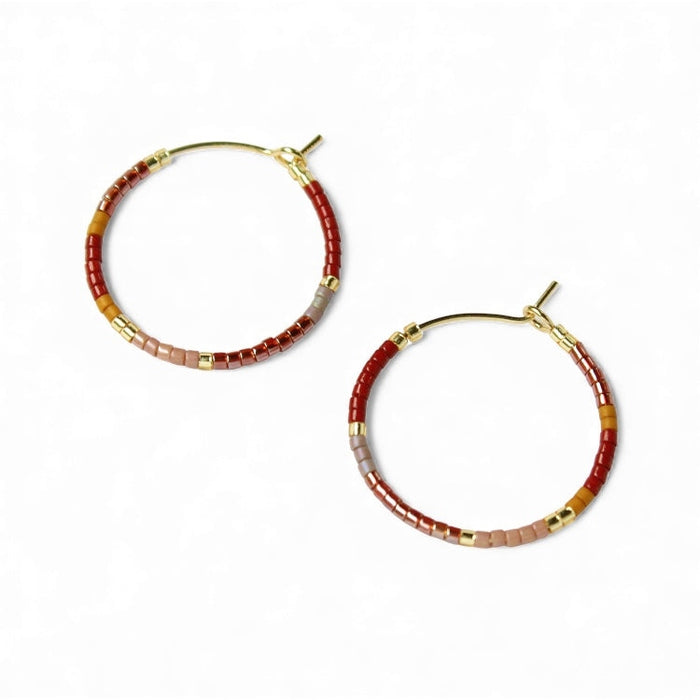 Pair of beaded hoop earrings with gold-tone hooks; red and gray beads with gold squares.