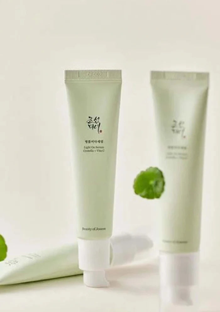 Two green skincare products with a white background