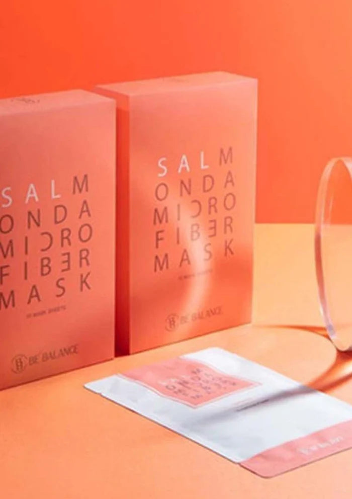 Two salmon-colored boxes of 'Salmon Microfiber Mask' on an orange background