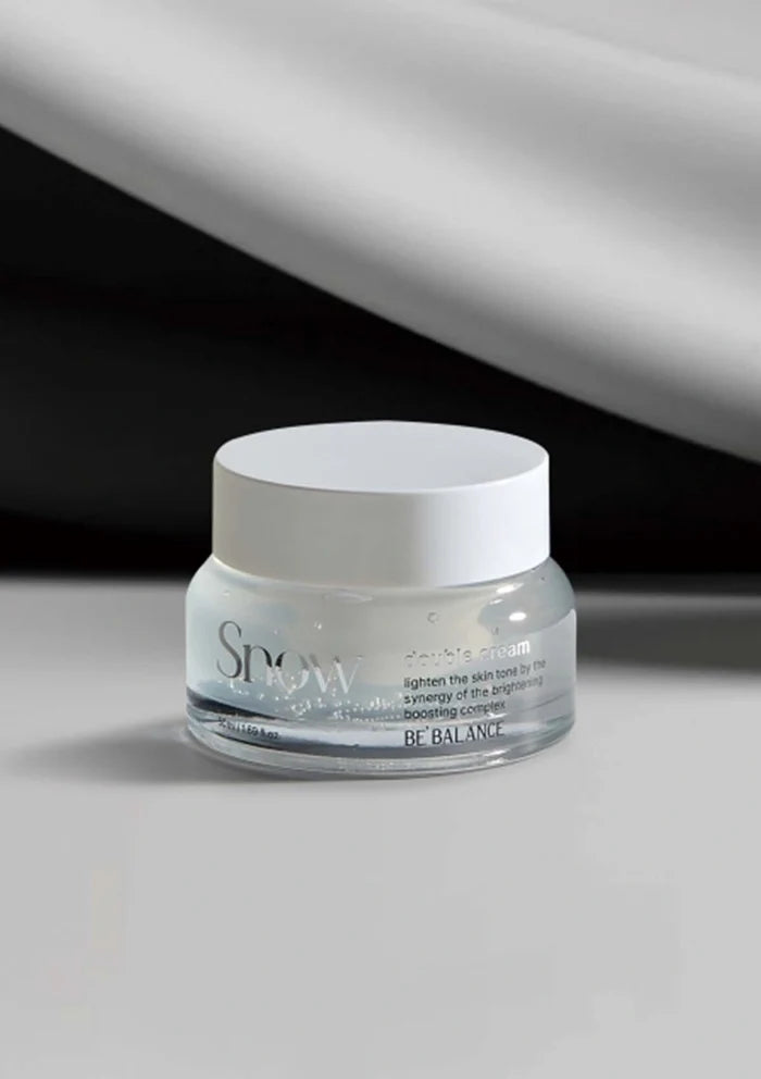 Skincare jar labeled 'Snow' on a gray background