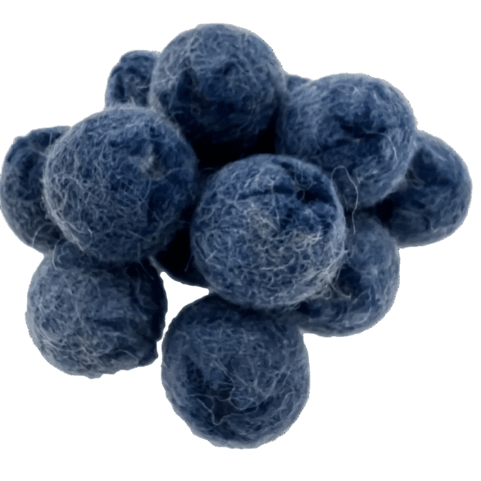 Pile of felted blueberries on a white background