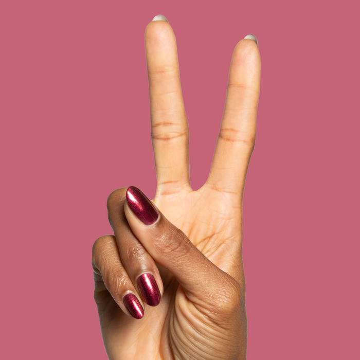 Budget? What Budget deep rose-orange duochrome gel polish on almond-shaped nails for a chic mani by Olive and June