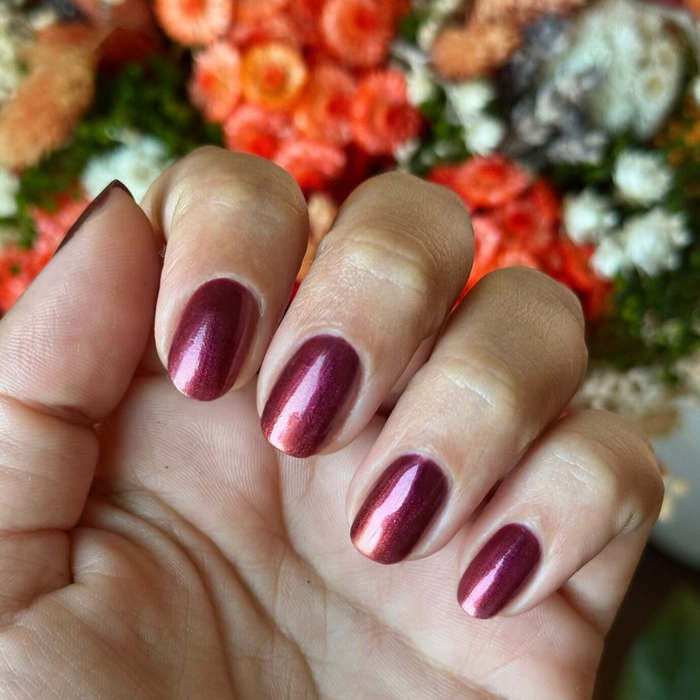 Budget? What Budget deep rose-orange duochrome polish on natural nails for a stunning manicure by Olive and June