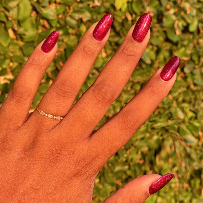 Budget? What Budget deep rose-orange duochrome gel polish on almond-shaped nails for a luminous mani by Olive and June