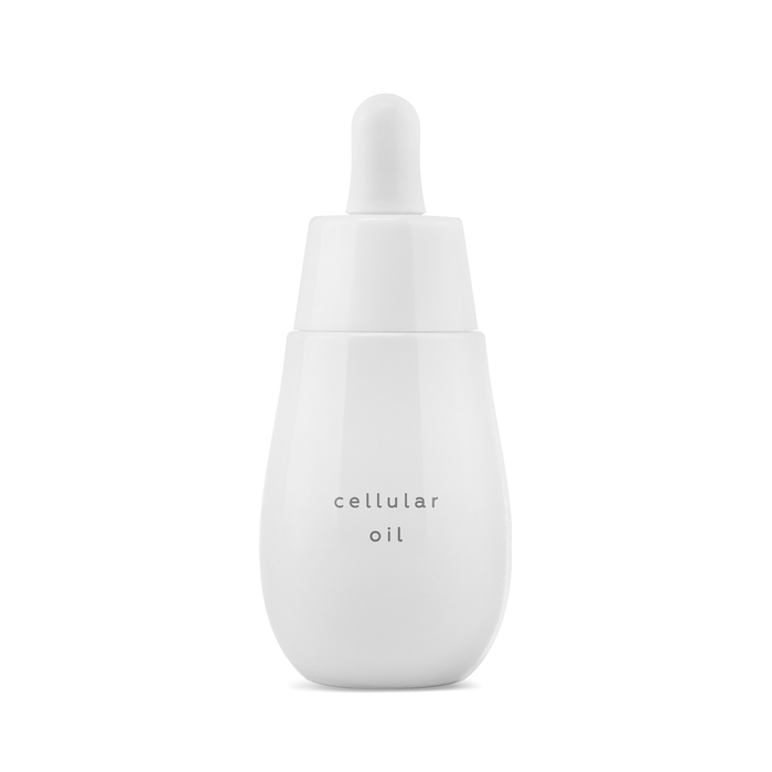 A white bottle with dropped of Cellular Oil by Ayuna on a white background.