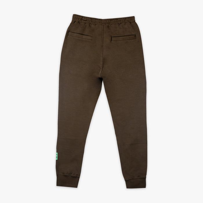 Brown sweatpants with a small green logo on a white background