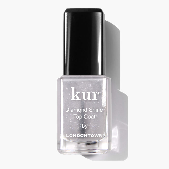 Clear bottle of LONDONTOWN Diamond Shine Top Coat nail polish with a black cap, labeled in white text. Infused with diamond-dusted particles, this top coat ensures extended wear and adds irresistible dimension to your manicure.
