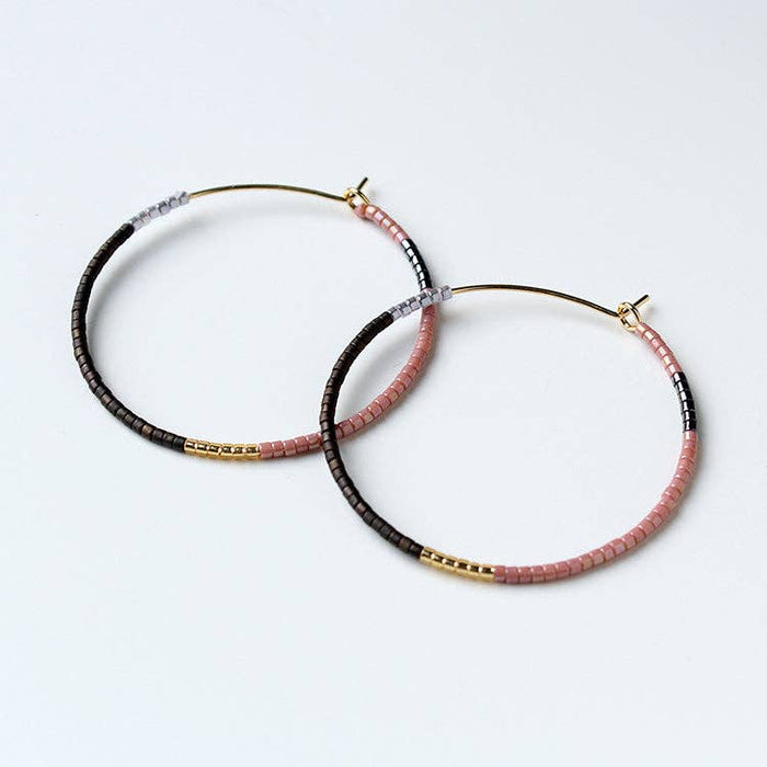Beaded hoop earrings with black, pink and gold accents, small stud closures