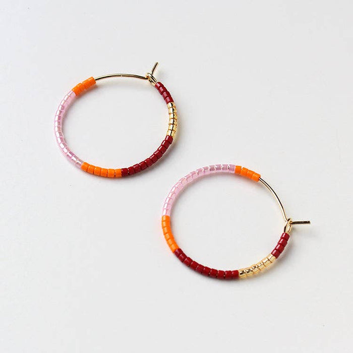 Beaded hoop earrings with pink, orange, and red bead accents