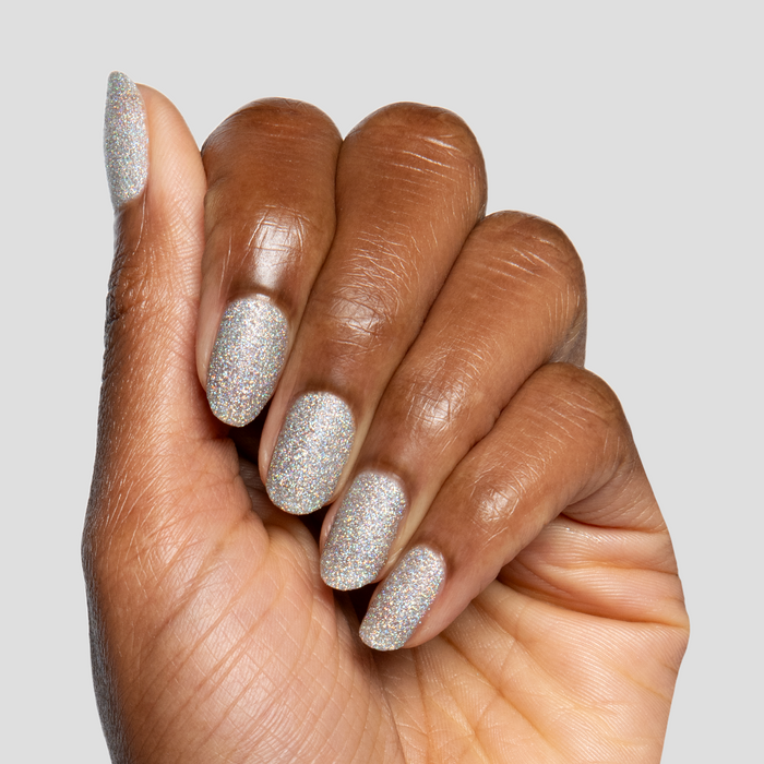 Glitter Department ultra fine holographic silver polish on natural nails for a sparkling at home manicure look by Olive and June