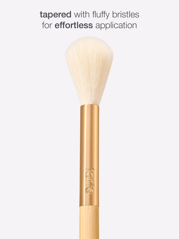 Tarte blush makeup brush with fluffy bristles on a white background