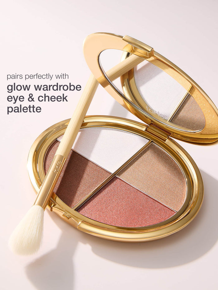 Makeup palette with a brush on a light background