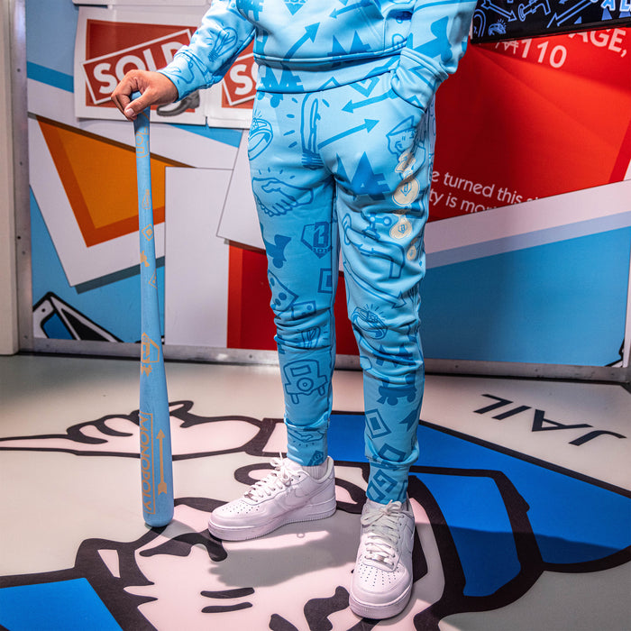 Youth model wearing blue youth joggers with “Grand Slam Collector Relaxed Fit” design