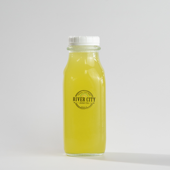 Bottle of yellow juice with 'River City Juice Co.' label on a white background