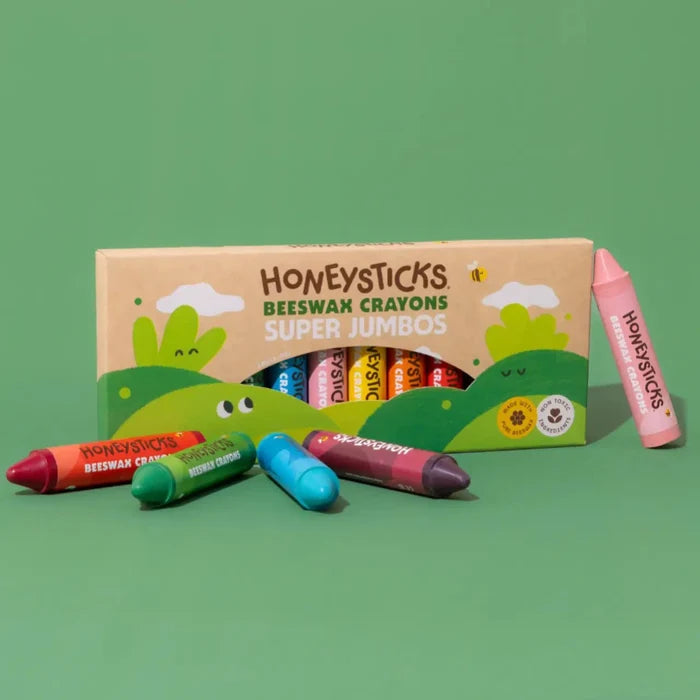 Box of Honeysticks Super Jumbo crayons on a green background