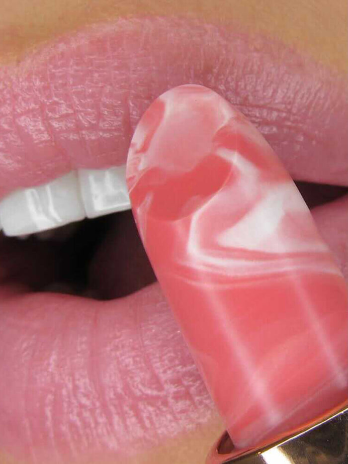 Dreamy -- close up of model applying Marbleous lip balm on lips
