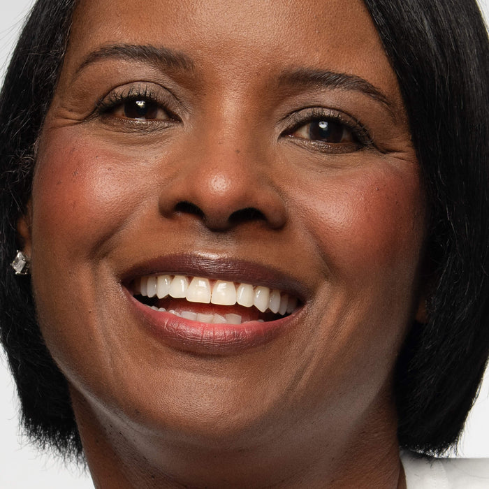No Makeup Makeup – Close-up of a woman with dark skin wearing plum blush shade on cheeks and lips, natural minimal makeup