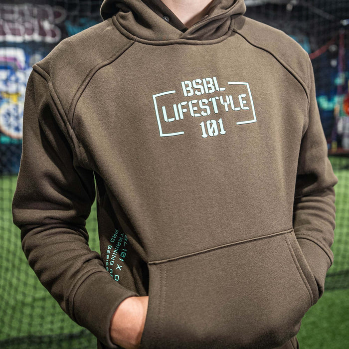 Youth model wearing brown and mint Off-Field Performance youth hoodie