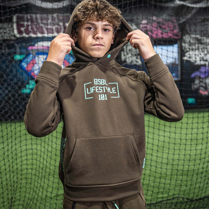 Youth model wearing brown and mint Off-Field Performance youth hoodie