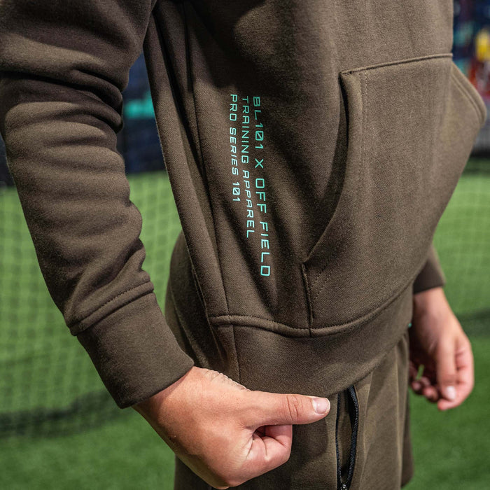 Youth model wearing brown and mint Off-Field Performance youth hoodie
