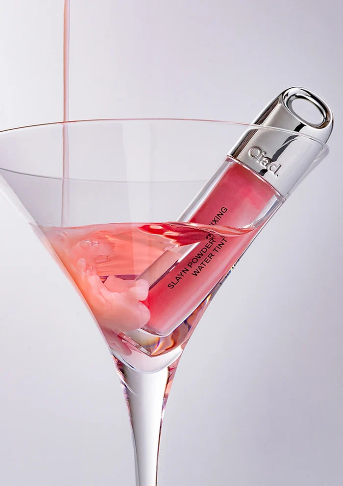 Lip gloss in a martini glass with a white background