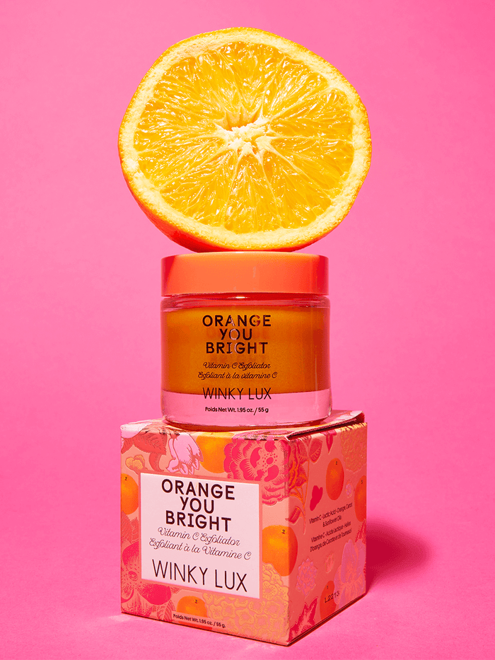 orange you bright vitamin c exfoliator sitting on box with orange on top