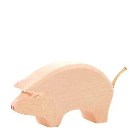 Wooden pink pig on a white background