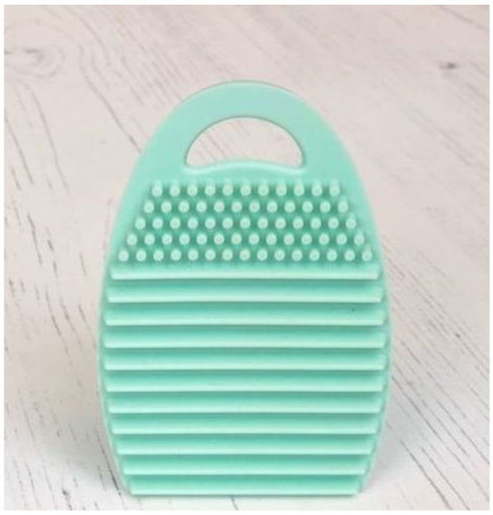 Taylored Expressions - Brush Scrubber. The Blender Brush Cleaning Tool is a special silicone tool that can help remove excess ink from your TE Blender Brushes, while helping the bristles maintain their original shape and texture. Simply apply gentle soap and water to the brush and work it into the bristles using the tool. Then make sure your brushes have the bristles pointing down and let air dry. Available at Embellish Away located in Bowmanville Ontario Canada.