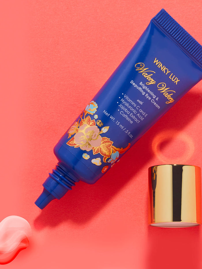 wakey wakey eye cream flat lay with cap off and product coming out