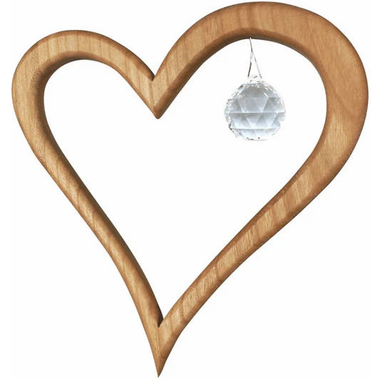 Wooden heart-shaped suncatcher with  crystal on a white background