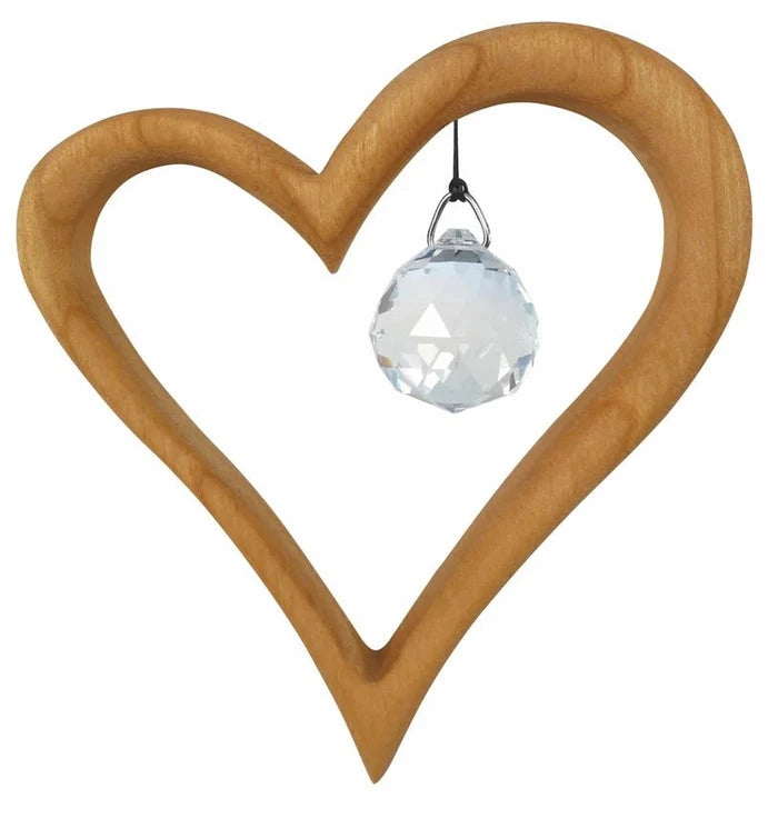 Wooden heart-shaped suncatcher with a clear crystal ball on a white background