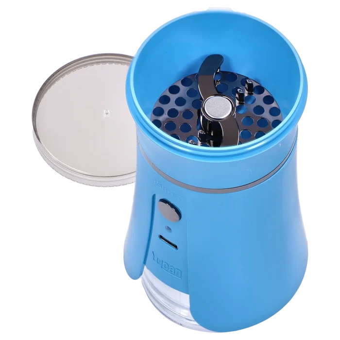 Top-down close-up of the open Yocan iShred Electronic Grinder – Blue showing its metallic dual blades and perforated grinding plate inside the bright blue housing