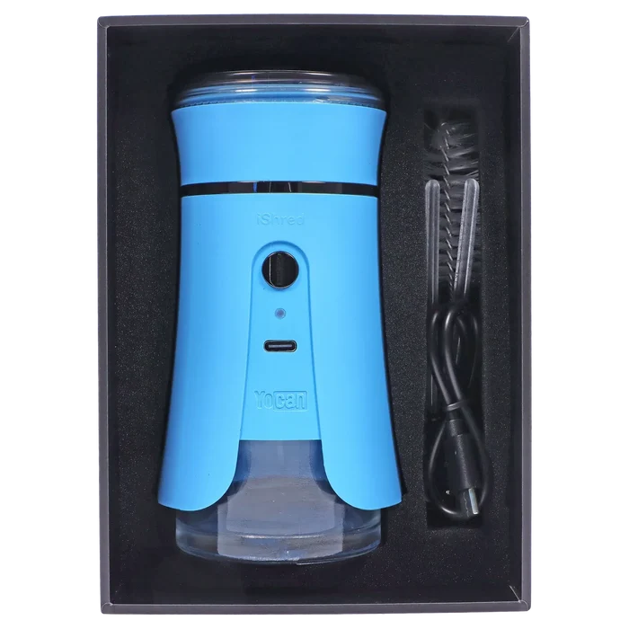 Top-down view of the blue Yocan iShred Electronic Grinder seated in its black foam tray with a USB cable and cleaning brush alongside